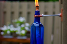 DIY bold blue wine bottle with copper fixtures to attach to the wall