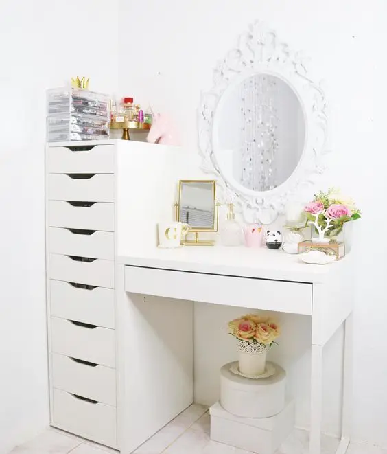 a chic makeup nook with several mirrors and a large drawer unit used for makeup storage