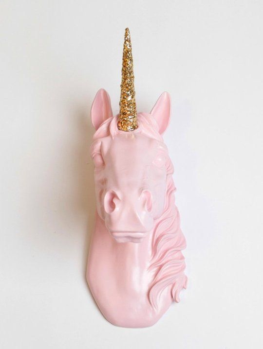 a pink unicorn head with a gold glitter horn is a cute and glam decoration