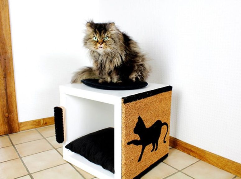 a scratching piece and cat bed in one made of IKEA Kallax unit