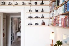 10 wooden shelves over the door is a great idea to use the awkward space and display cameras