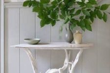 15 a little coffee table of driftwood as legs and a thin white wooden tabletop for a small entryway