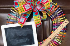 DIY colorful crayon wreath with a chalkboard and an apple
