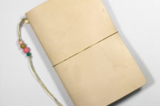 DIY leather travel journal with colorful floral lining