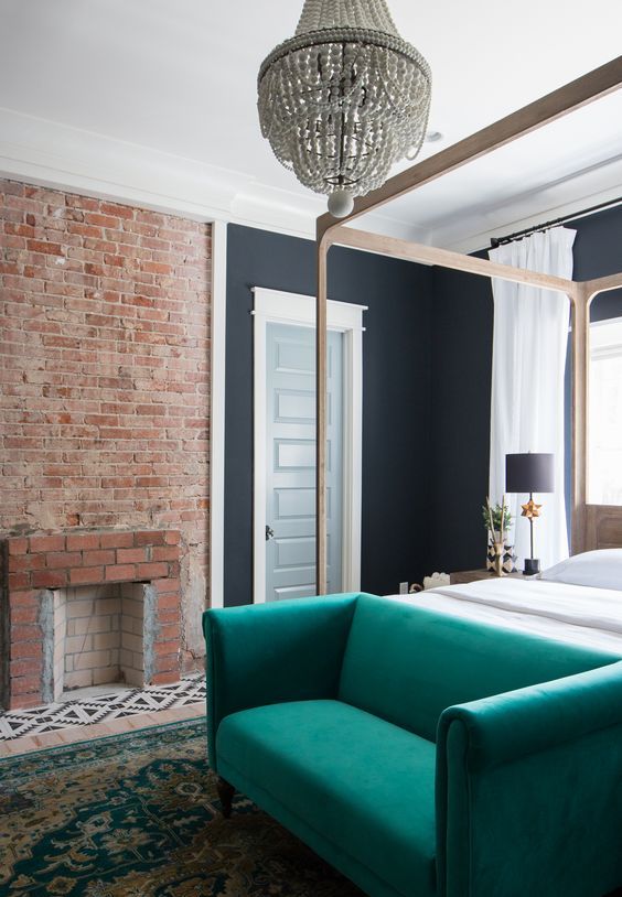place an emerald sofa at the bed to use it for storage and to make a colorful statement
