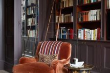 06 a sophisticated rust velvet chair with gilded legs to create an elegant reading space