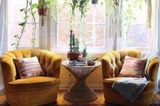 07 a boho sitting nook by the window with a couple of mustard velvet chairs and much greenery