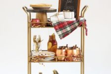 07 a gorgeous fall bar cart with white pumpkins on the lower shelf, plaid blankets and faux berries