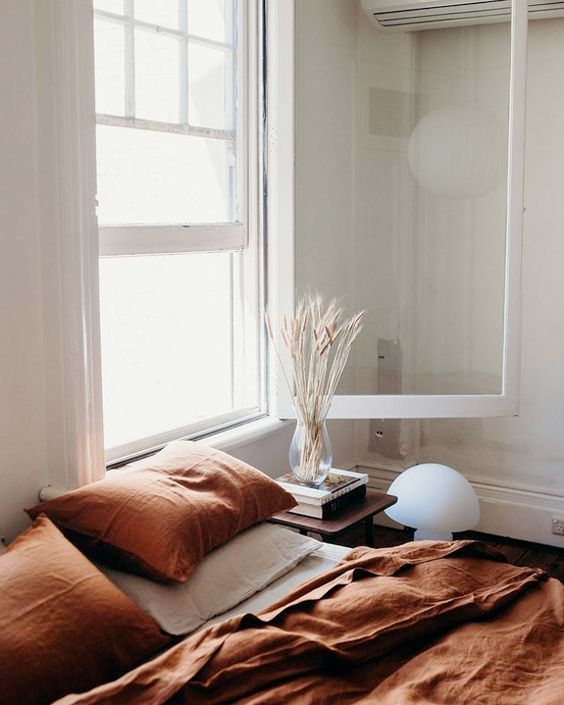 a rust bedding set for a neutral bedroom screams fall at once and brings fall vibes