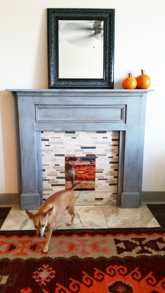 DIY faux brick fireplace with a faux mantel of wood (via www.wellmadeheart.com)