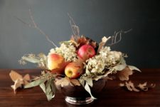 DIY fall centerpiece with apples, dried leaves and hydrangeas