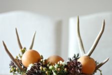 DIY woodland-inspired centerpiece with antlers, pinecones and apples
