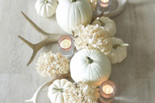 DIY elegant white rustic centerpiece with antlers and pumpkins