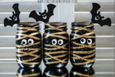DIY black and gold mummy treat jars with bats