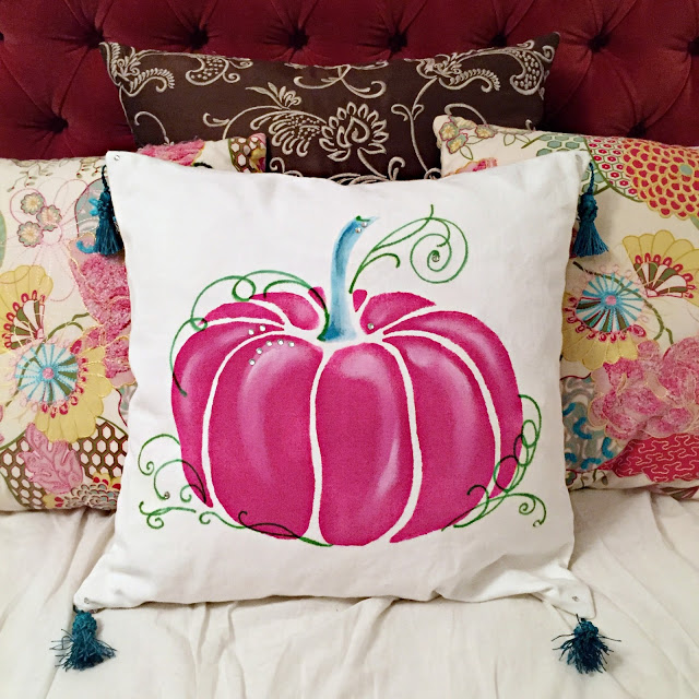 DIY pink pumpkin pillow with tassels on corners (via www.justalittlecreativity.com)
