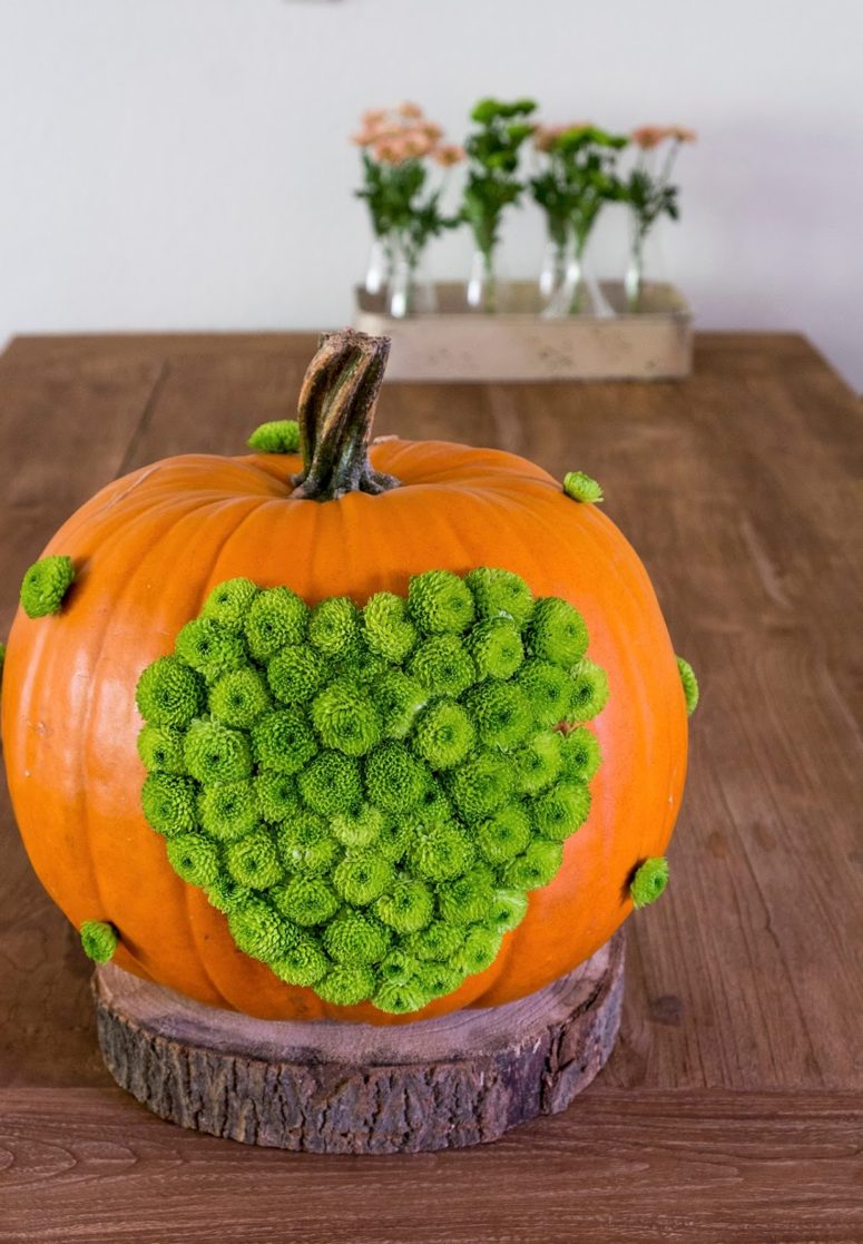 DIY orange pumpkin dotted with green mums (via www.elsarblog.com)