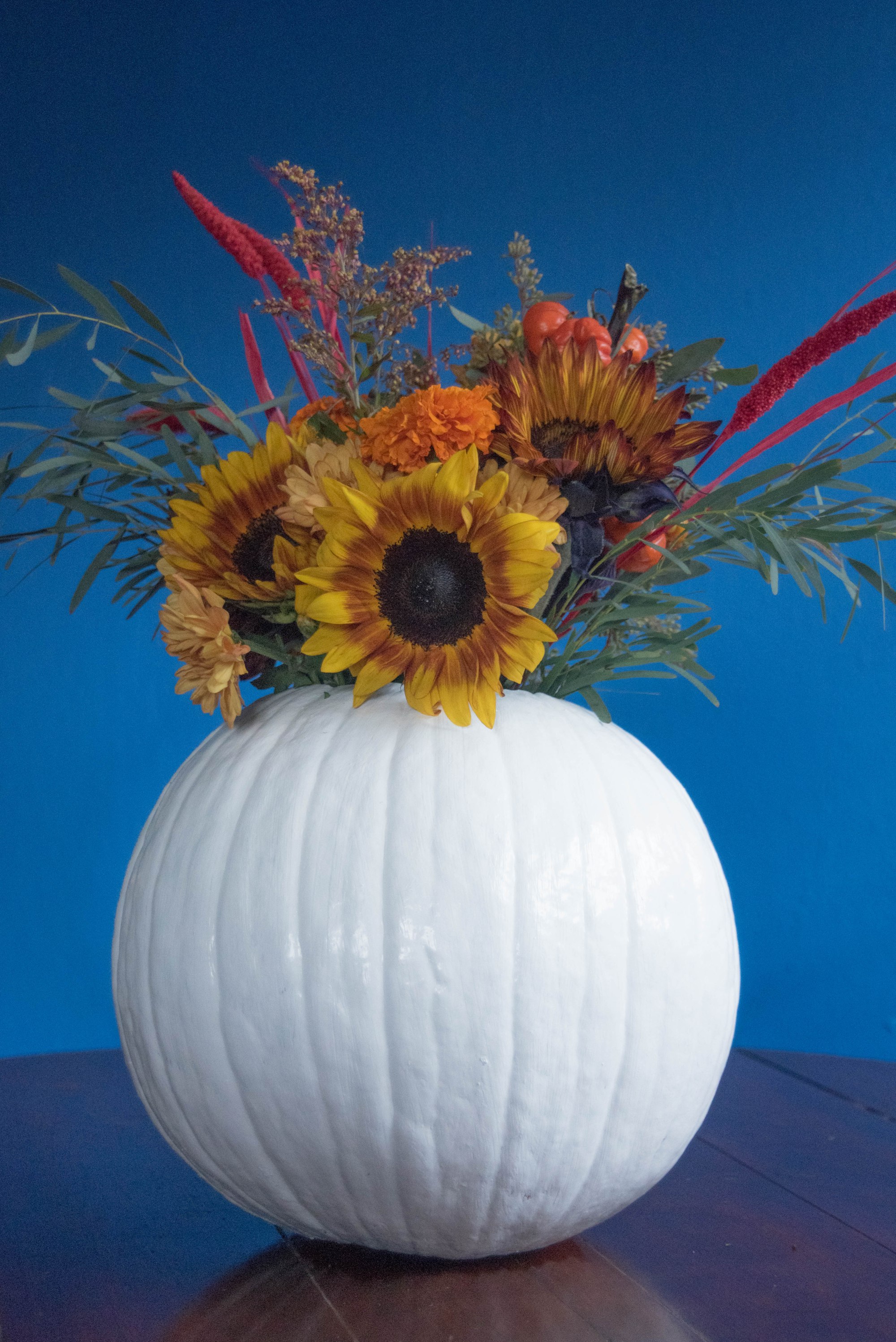 DIY faux pumpkin vase with a faux floral arrangement