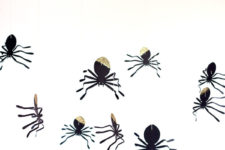 DIY glitter spiders hanging on balloons