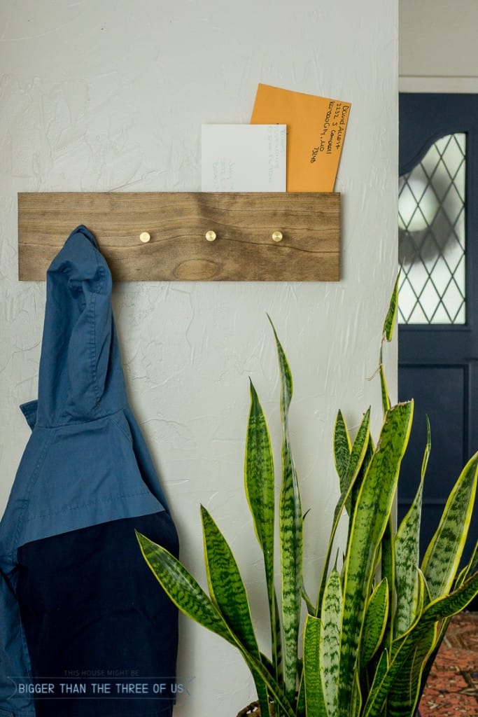 DIY stained wood coat rack with metal dowels