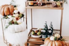 a gorgeous Thanksgiving bar cart with pears and apples, pomegranates, fall blooms and pumpkins around