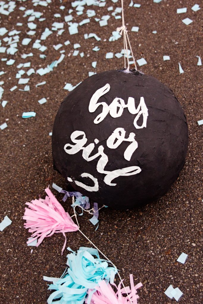 DIY gender reveal pinata of a black ball and with clothes inside (via blog.guguguru.com)