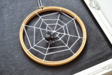 DIY spiderweb artwork of an embroidery hoop