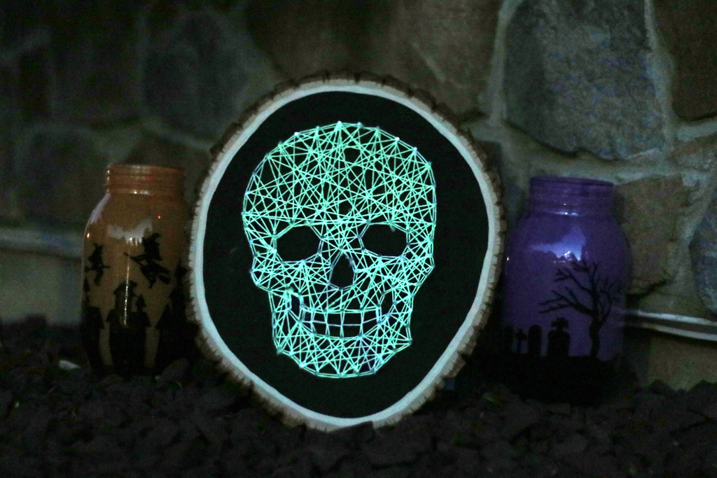 DIY glowing skull string art craft for Halloween (via www.wholesalepartysupplies.com)