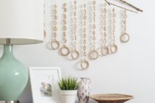 DIY boho wall hanging of branches and wooden rings