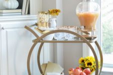 sometimes all you need for styling a bar cart is some apples in a basket and a bright sunflower arrangement