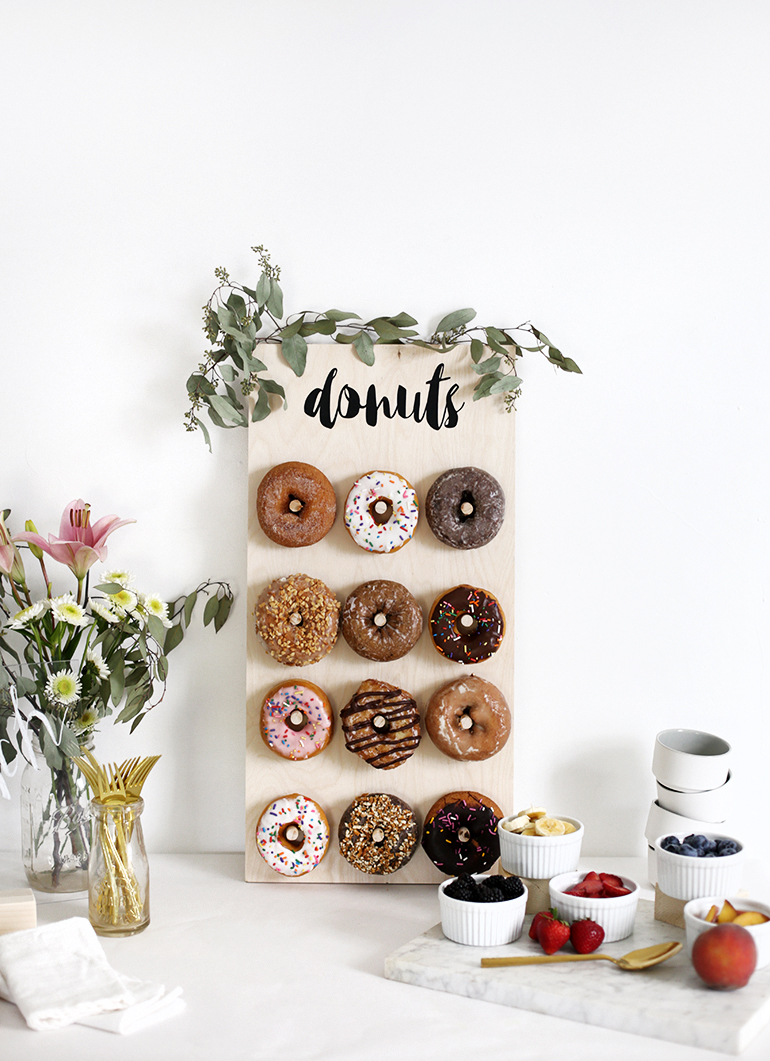 DIY mini donut wall of plywood decorated with eucalyptus (via themerrythought.com)