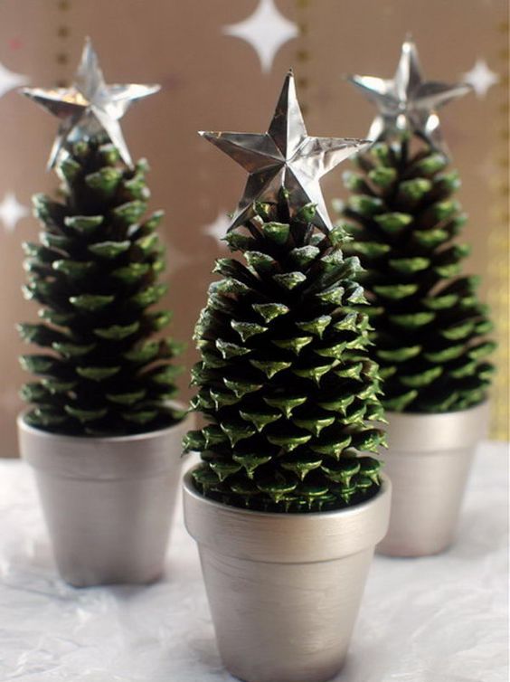 use large pinecones as Christmas trees, paint them green and add little stars on top