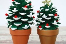 06 painted Christmas trees of oversized pinecones with colorful pompoms and little stars on top