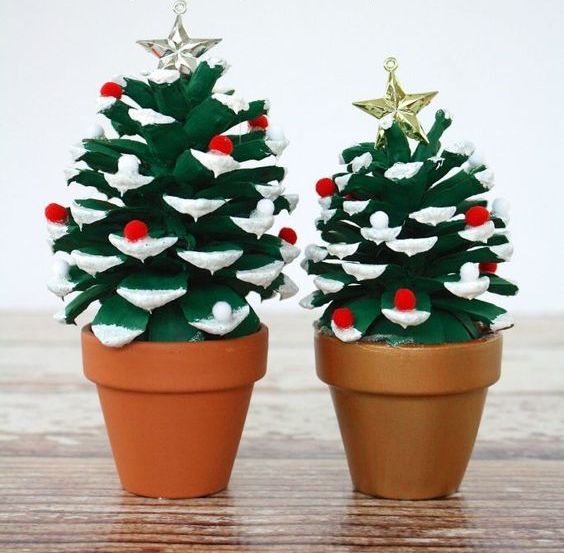 painted Christmas trees of oversized pinecones with colorful pompoms and little stars on top