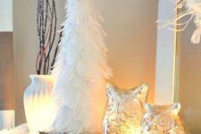 08 a cute winter mantel with owls, lights, cotton and a feather Christmas tree in pure white