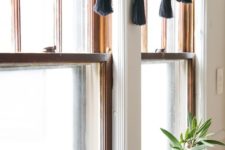 10 an elegant black and copper holiday tassel garland will spruce up your neutral window treatments