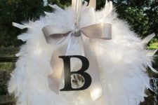 15 a lit up Christmas feather wreath decorated with a large bow and a monogram is amazing for holidays and looks so heavenly