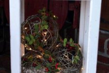 15 an outdoor lantern with vine balls, berries, foliage and LEDs for your porch and stairs
