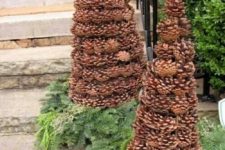 16 place pinecone Christmas trees outside on evergreens for a natural or rustic feel