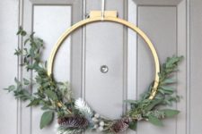 DIY moody Christmas wreath with greenery and pinecones