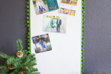 DIY cork board with pompom trim Christmas card display