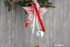 DIY Christmas ornament of a wooden star and jingle bells