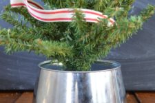 DIY galvanized bucket mini tree stand with plaid ribbon