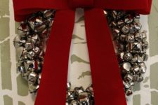 DIY large jingle bell wreath with a large red bow