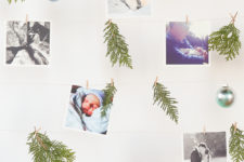DIY hanging picture wall with ornaments and greenery