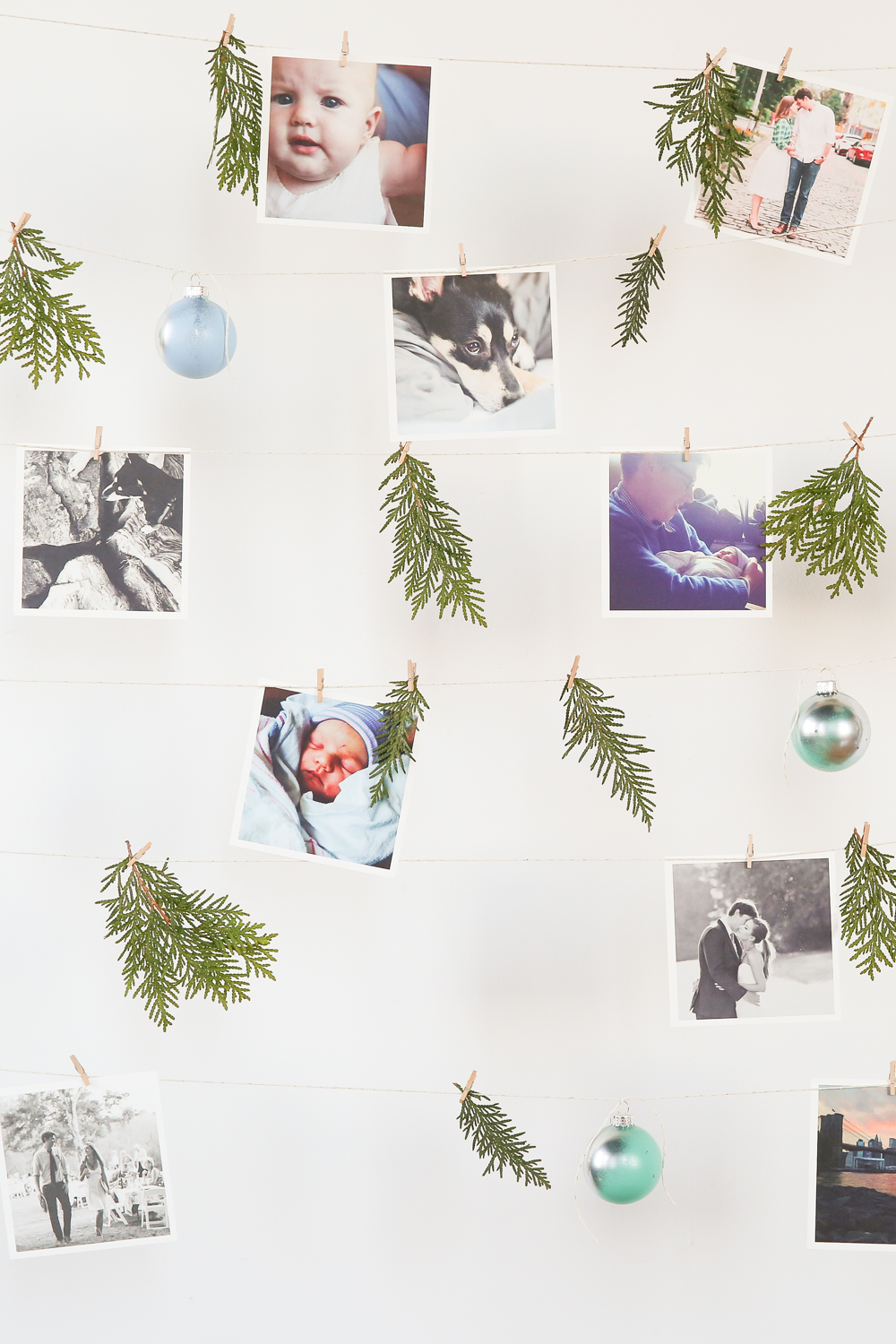 DIY hanging picture wall with ornaments and greenery