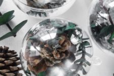 DIY clear Christmas ornaments with greenery and pinecones