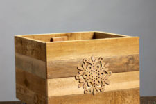 DIY rustic Christmas tree crate on casters decorated with a snowflake