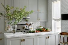 03 a classic dove grey kitchen with brass accents and vintage lighting plus white subway tiles