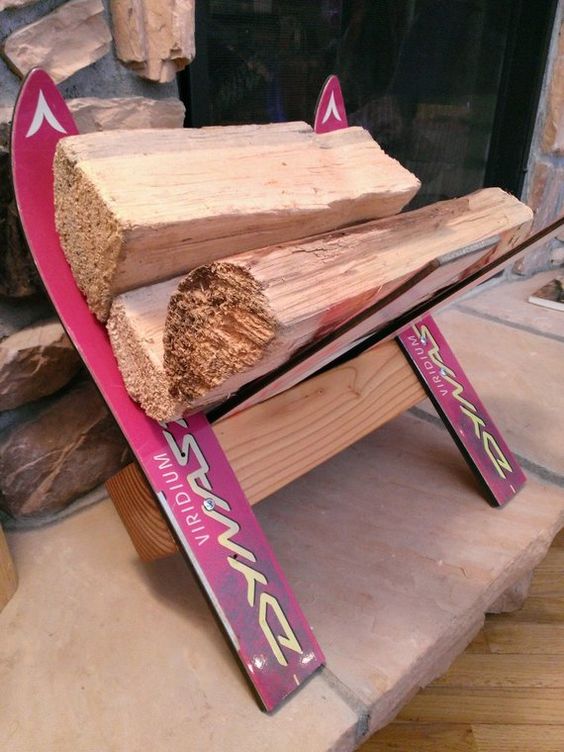 a firewood stand made of new and colorful skis is a cool piece to place next to your fireplace