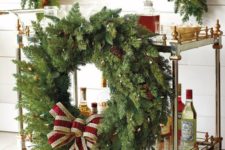 03 attach an oversized evergreen Christmas wreath with lights, ornaments and a large red bow